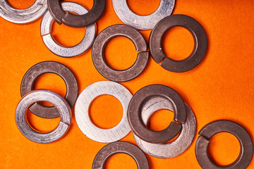 spring washers on orange background. Bolted connection elements