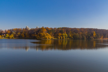 Fototapeta na wymiar Scenic view to the autumn park and pond, golden autumn