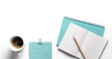office desk workspace with blank copy space. mockup with turquoise notebook and a cup of coffee on...