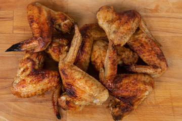 Baked chicken wings served on the wooden table