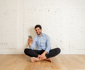 Young happy blogger with mobile phone taking video or selfie for blog at new home