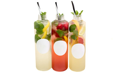 Summer lemonade bottles with lemon, strawberry. orange, cucumber, pomegranate, grapefruit .mint beverage cocktail isolated on white background