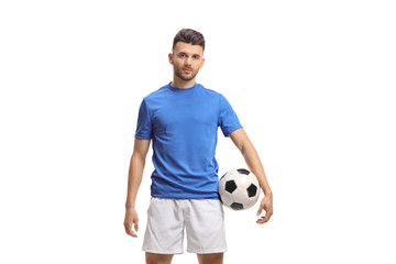 Soccer player with a football and looking at the camera