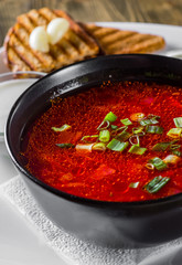 Beetroot soup Traditional Ukrainian or Russian borscht with sour cream in a bowl on wooden table