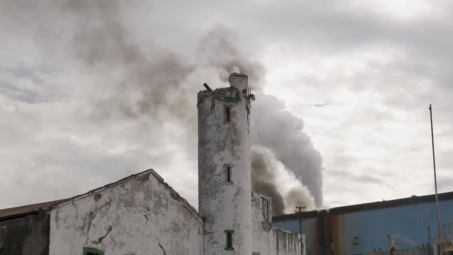 Smoke coming out of old factory chimneys in cloudy day. Industry environmental pollution, Izucar de Matamoros, Mexico