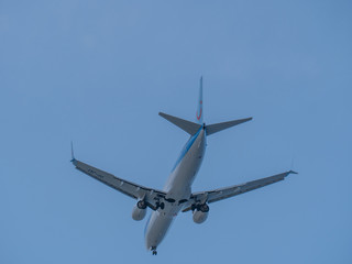 Big passenger airplane flying in blue sky