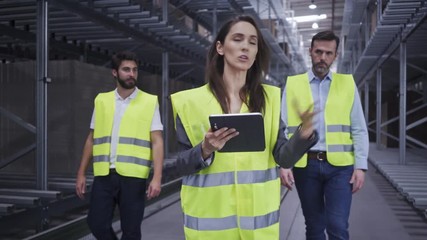 Chief industrial engineer showing newly hired employees around factory and explaining