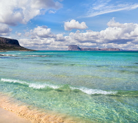 Obraz premium Amazing Mediterranean beach, clear blue calm sea, island in the background and beautiful sky