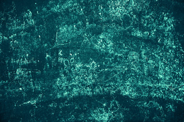 Vintage azure background. Rough painted wall of turquoise color. Imperfect plane of cyan colored. Uneven old decorative toned backdrop of aqzure tint. Texture of teal hue. Ornamental stony surface.