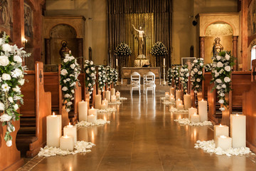 Catholic temple decorated with flowers and candles for wedding