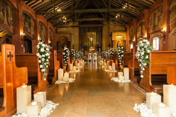 Catholic temple decorated with flowers and candles for wedding