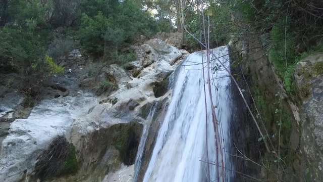 Tilt down on a waterfall feeding a stream at Lassa, Mount Lebanon