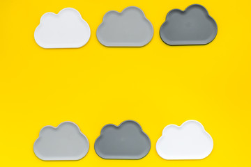 cloud computing concept with clouds on yellow background top view space for text