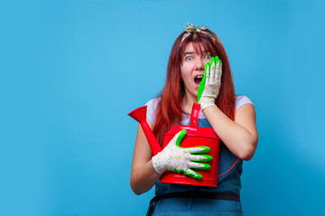 Photo of surprised female florist with watering can in hands