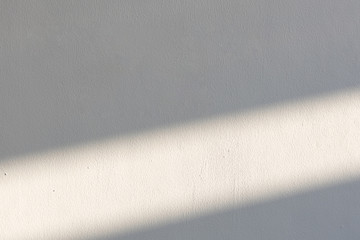 simplicity empty white cement wall with line of sun light and shadow at afternoon. used for...