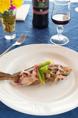 sea bass with onion and mint typical dish of the Aeolian islands in Sicily