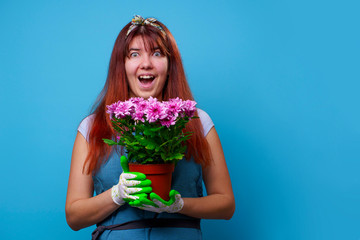Photo of surprised brunette woman with chrysanthemums