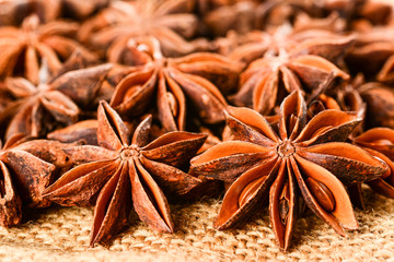 Star anise. Some star anise fruits with seeds 2. Macro close up on the jute burlap canvas.