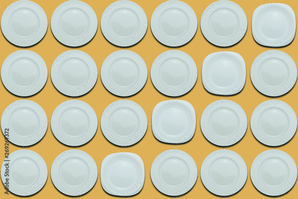 Poster white round plates and one different plate on a yellow flat background. copy space