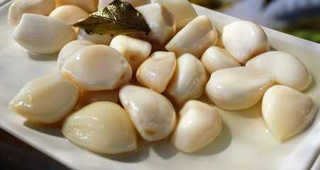 Dish with pickled white garlic cloves