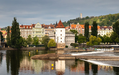 Beautiful Vltava river in Prague with old town and historical buildings in the background