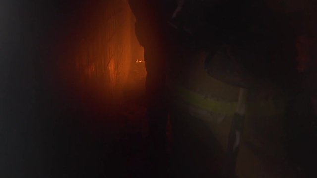 Fire fighting.First person.The work of firefighters inside the burning object.Fire and smoke.