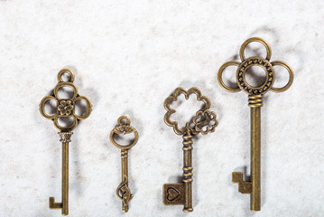 Decorative keys of different sizes and styles on grey background