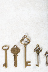 Decorative keys of different sizes and styles on grey background