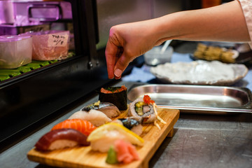 preparation of japanese food including sushi and salad