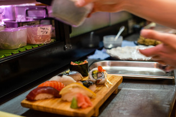 preparation of japanese food including sushi and salad