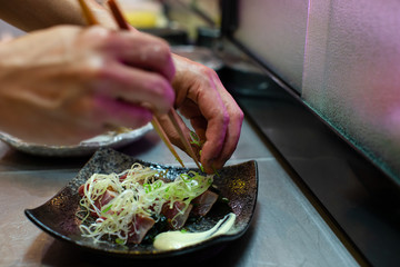 preparation of japanese food including sushi and salad