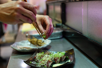preparation of japanese food including sushi and salad