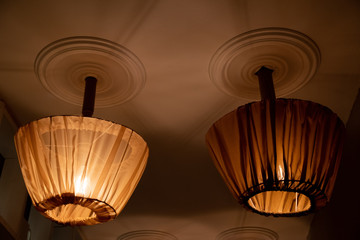 Two ceiling lamps with retro style lampshades draped with tulle covers. Lamp shades sewed from...