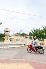 khmer man riding motorcycle on the street in Battambang.