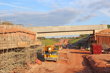 Fototapeta na wymiar Mobile crane by a bridge under construction