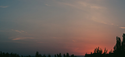 Obraz premium Landscape with dramatic light - beautiful golden sunset with saturated sky and clouds.