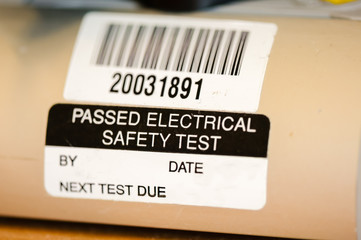 Sticker on an electrical appliance stating that it has passed a safety test - obrazy, fototapety, plakaty