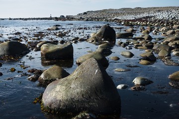 beautiful mountain landscape, stones, green grass, blue sea,