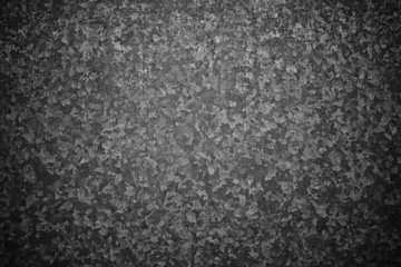 Schwarz Grau Metallic Hintergrund mit dunkler Vignette, gebürstetes metall Muster. Metallische Struktur als HIntergrund und Textur. Tafel und gestalterisches Element.