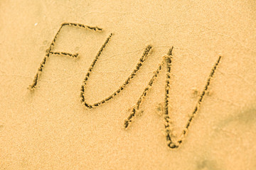 Signs on sand beach written by hand, inspire to travel to exotic islands and relax. Words Ocean, fun, happy and smile on yellow beach. Family tour travel time in summer resort. Enjoy your holidays