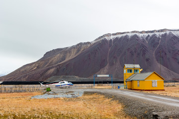 The sudden abandoned russian mining town Pyramiden, snowcaped mo