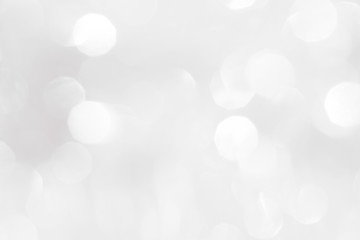 A brilliant white background with circles and ovals. Template for a holiday card with bright and sparkling lights.