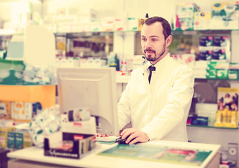 Pharmacist writing down assortment of drugs