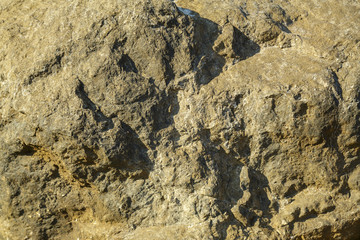 Fragment of stone rocks close-up. Texture. Horizontal frame