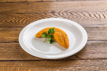 deep fried fish in batter isolated on wooden background