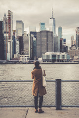 Young man wearing winter clothes enjoying the view of New York. Street photo concept.