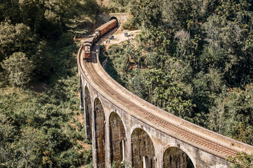 Blue train goes through jungle. Nine arch bridge, Demodara, Sri Lanka. Old bridge in Ceylon. Nine Arches Bridge from above, Sri Lanka. © Anastasia