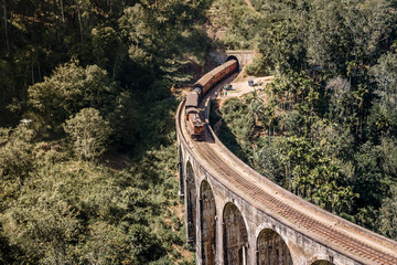 Blue train goes through jungle. Nine arch bridge, Demodara, Sri Lanka. Old bridge in Ceylon. Nine Arches Bridge from above, Sri Lanka.