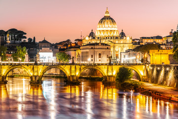 Fototapeta na wymiar St Peters Basilica in Vatican and Ponte Sant'Angelo Bridge over Tiber River at dusk. Romantic evening cityscape of Rome, Italy