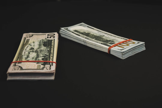american Dollars banknotes isolated on black background.